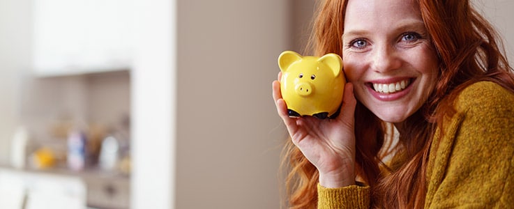 happy woman with piggy bank