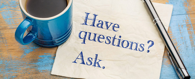 coffee mug and pen with napkin reading have questions ask