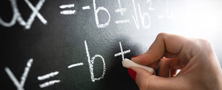 woman doing chalkboard arithmetic