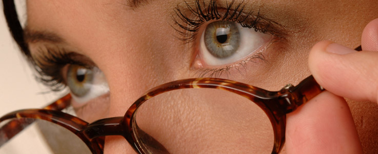 woman peering over glasses
