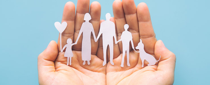 hands holding paper family cut out