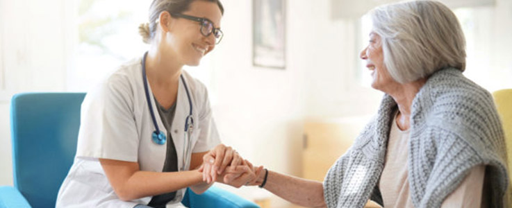doctor holding hands with elderly patient
