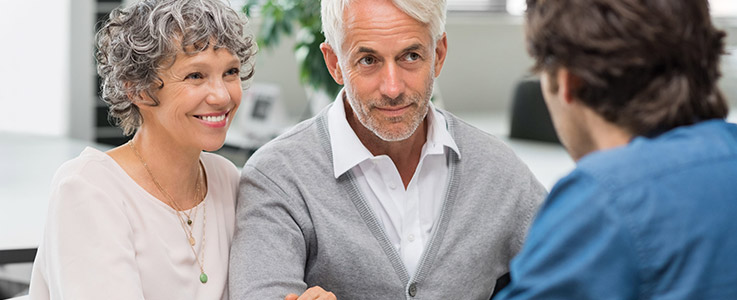 retired couple happily being consulted