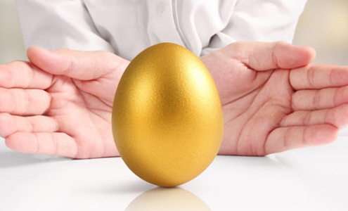 hands presenting golden egg