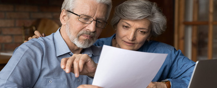 retired couple looking over papers