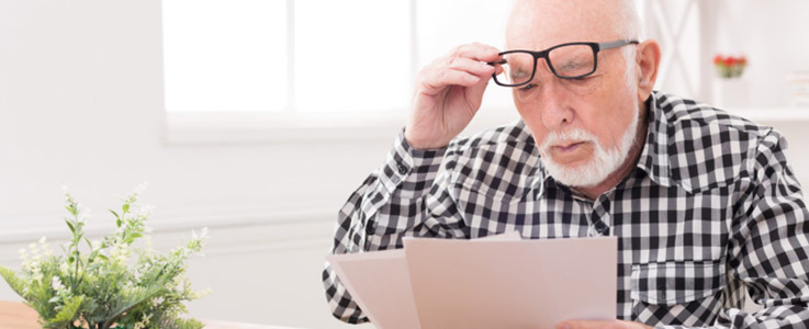 retired man overlooking papers