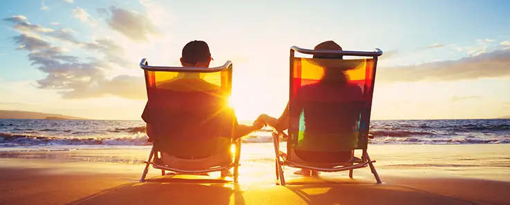 retired couple beach chairs