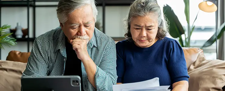 retired couple overlooking documents