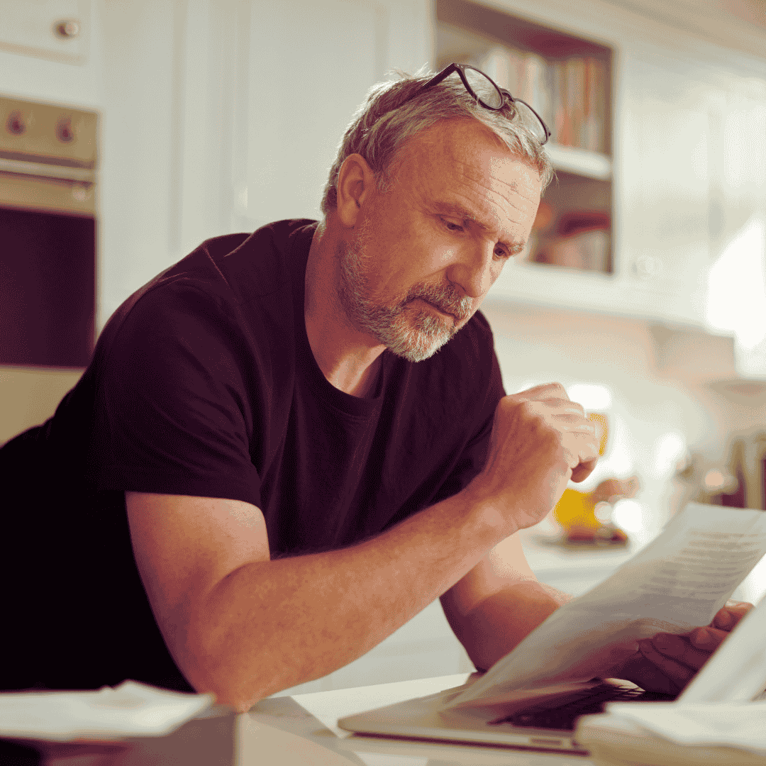 older man looking at financial information to make a decision