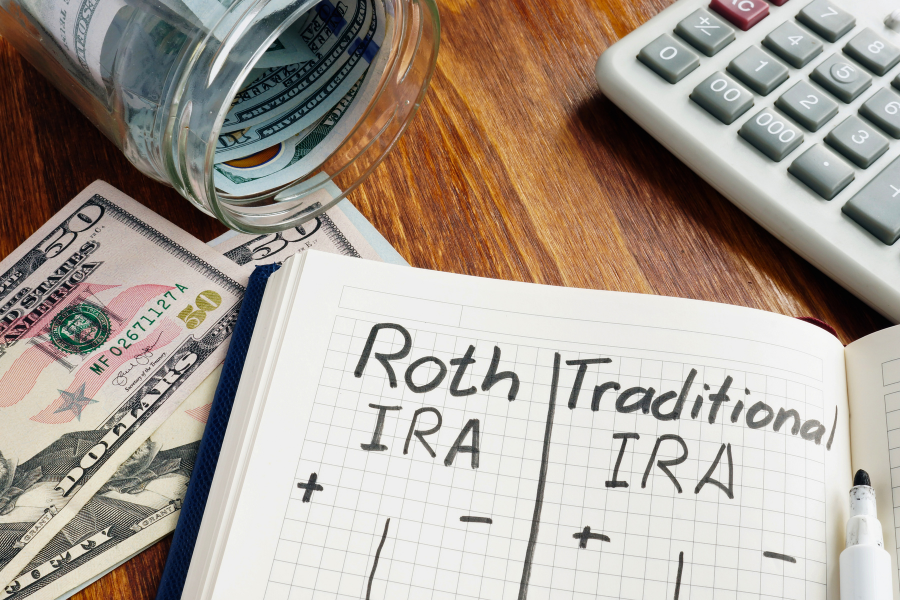 Comparison table between Roth IRA and Traditional IRA written in a notepad